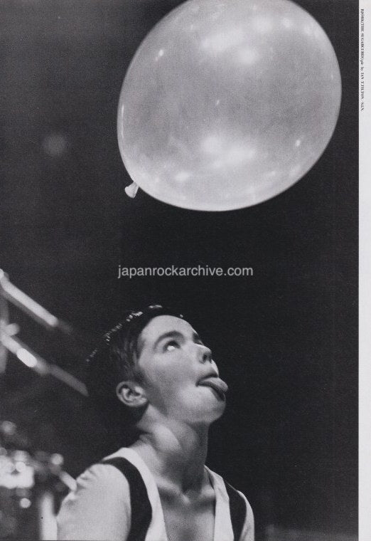 japanese magazine pinup photo of Bjork sticking out tongue while looking up at balloon