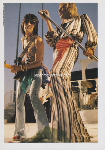 Ronnie Wood and Rod Stewart of Faces performing on stage with a focus on their costumes and instruments.