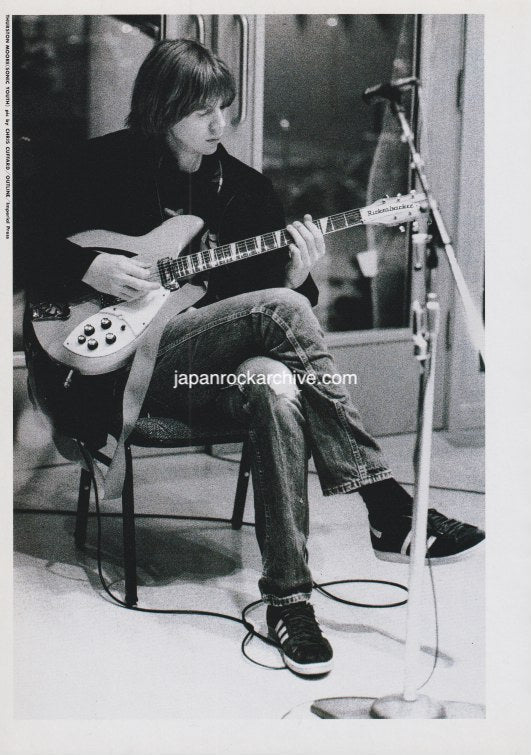 thurston moore od sonic youth playing a rickenbacker guitar in a studio setting wearing adidas sneakers