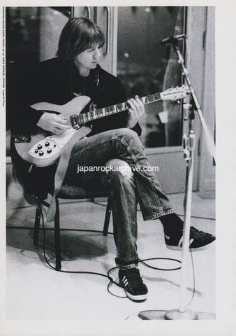 thurston moore od sonic youth playing a rickenbacker guitar in a studio setting wearing adidas sneakers