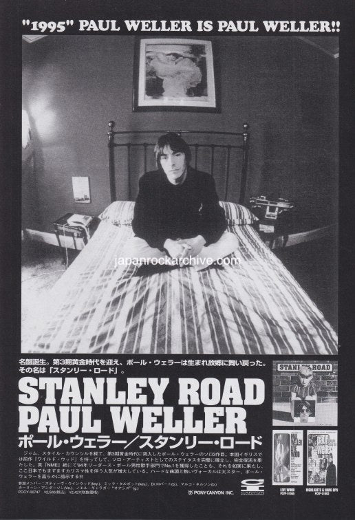 Black and white Japanese promo ad for Paul Weller Stanley Road album with album cover of Paul sitting on a bed with text and images around him.