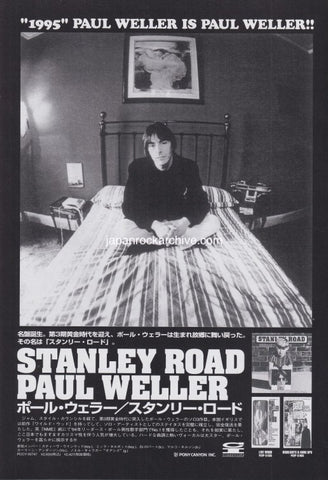 Black and white Japanese promo ad for Paul Weller Stanley Road album with album cover of Paul sitting on a bed with text and images around him.