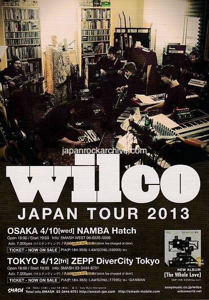 A promotional flyer for Wilco Japan Tour 2013 featuring a photo of the band members with musical equipment and books in the background.
